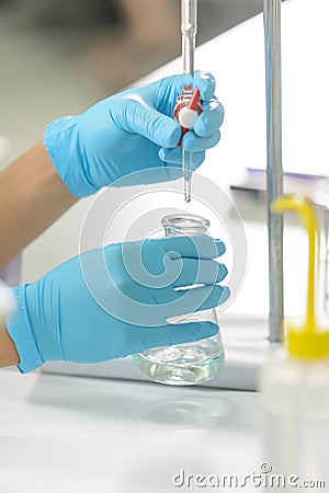 The woman whoâ€™s the scientist is demonstrate the titration technique Stock Photo